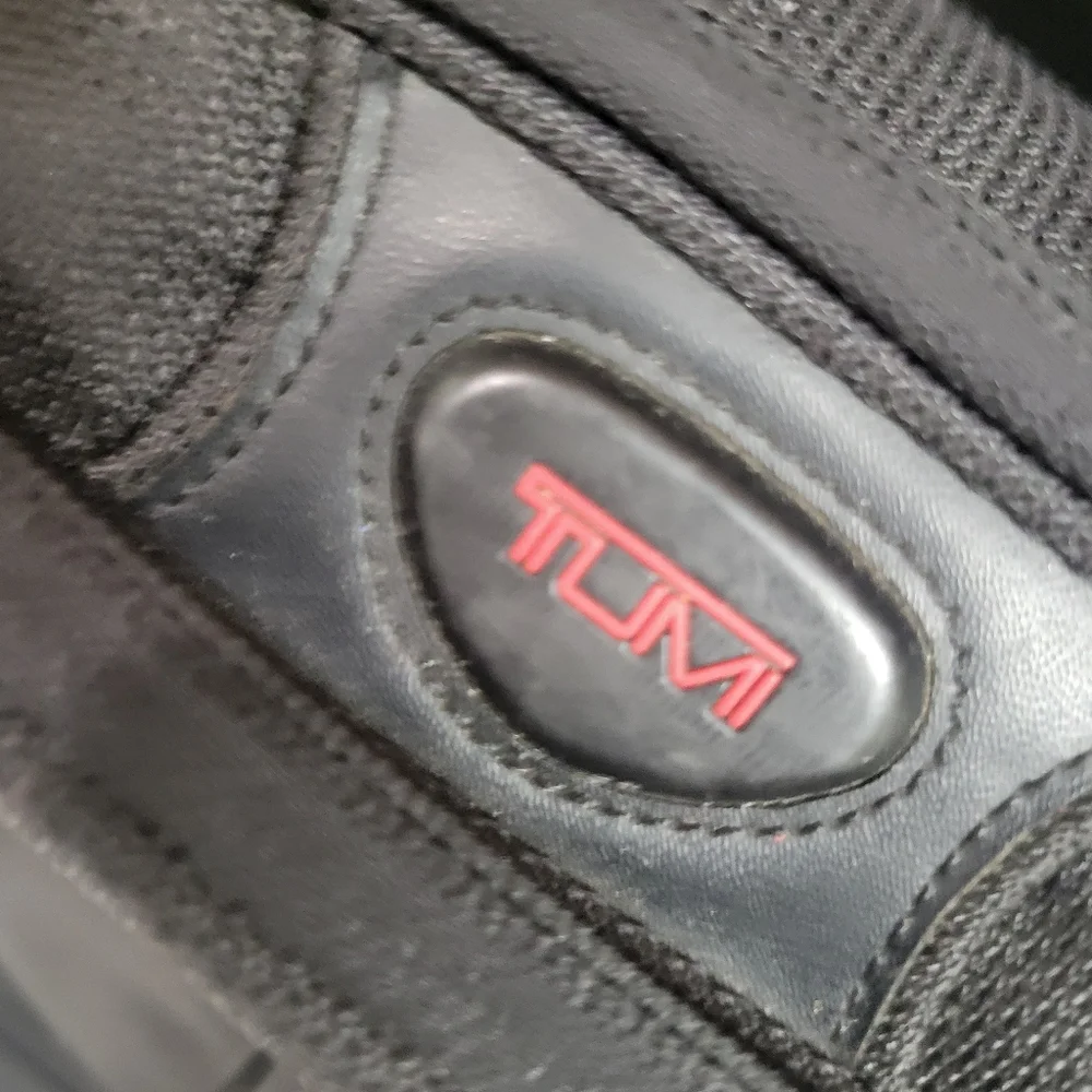 TUMI Black Backpack with Padded Straps and Multiple Compartments
